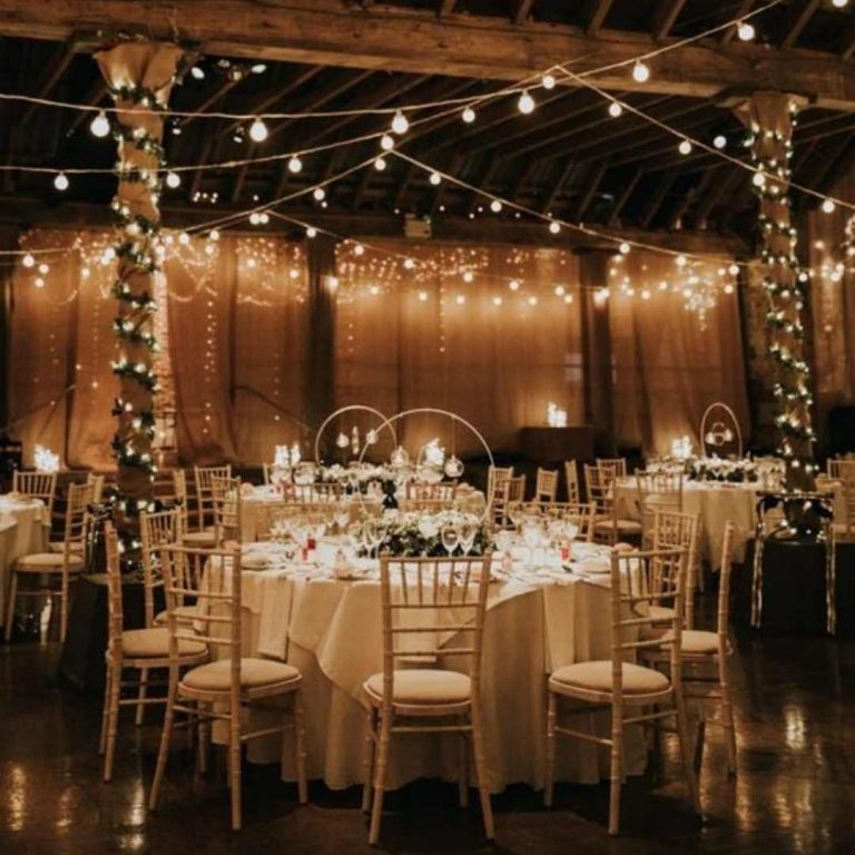 Pretty festoon and fairy light setup at wedding